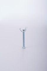 Long screw with knurled steel bolt on a white background