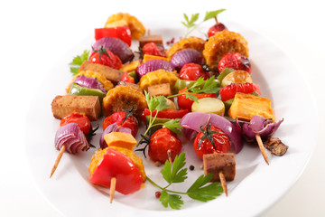 vegetarian barbecue party with corn, tomato, onion, tofu