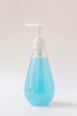 Bottle of alcohol gel and stack of facial mask or medical mask, Image for personal protection from corona virus covid-19 concept.  