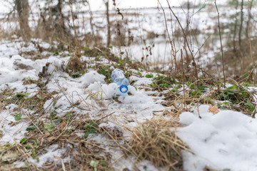 plastic bottle lying on the ground in the forest. ecological problem of forest pollution