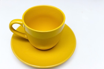 Empty yellow cup on White background.