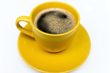 Yellow cup of hot coffee on white background