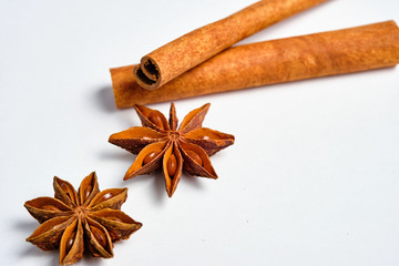 Anise stars, Badian and cinnamon on a white background, space for text,lat lay.