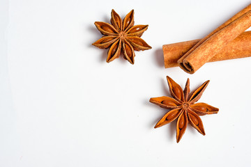 Anise stars, Badian and cinnamon on a white background, space for text,lat lay.