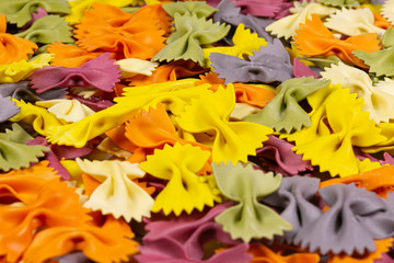 colorful Italian pasta background. Various colors of bow tie farfalle pasta. Top view