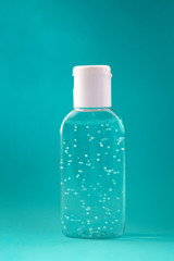 A bottle of hand sanitizer gel. Hand hygiene as coronavirus protection. Antivirus and antibacterial product. Blue liquid with white round granules