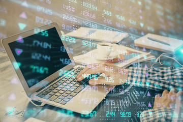 Double exposure of forex chart with man working on computer on background. Concept of market...