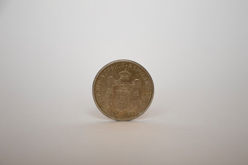Serbian dinar coin stands vertically on a white background.