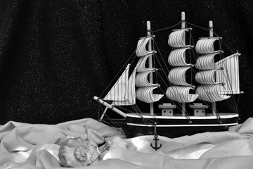 Ship at sea. This composition is assembled from a ship model, fabric and garland. As well as real...