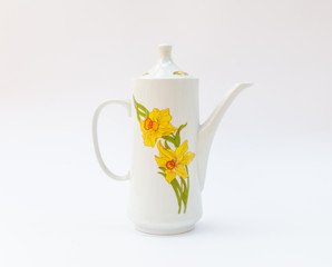 Vintage coffeepot with daffodil pattern - spring narcissus flower decoration - european porcelain kettle isolated on white background