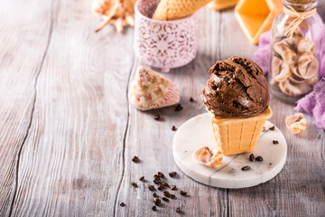 Delicious chocolate ice cream in waffle cone for dessert. Summer healthy food concept, lactose free, retro style toned. Copy space.