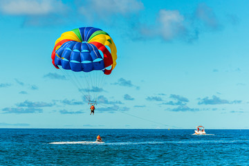 Fototapeta na wymiar Holidays at sea. Sea sports. Parachute and motor boat