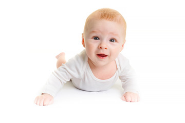 Adorable baby isolated on white.a small 4 month old baby lies on a white surface and smiles