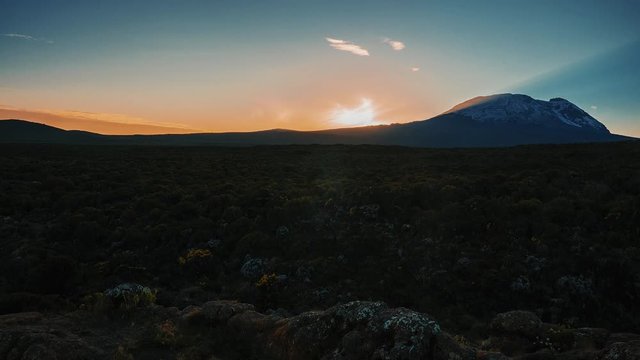 Timelapse view of Kibo with Uhuru Peak (5895m, highest mountain in Africa) at Mount Kilimanjaro, Kilimanjaro National Park. Beautiful landscape with clouds floating over the  volcano.