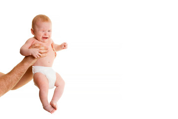 small 4 month old baby hold male hands on a white background.