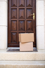 Contacless delivery service during quarantine. Two carton boxes delivered and left oudside ar...