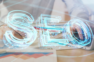 Multi exposure of seo icon with man working on computer on background. Concept of search engine optimization.