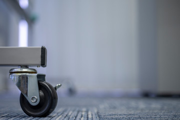 Small black rubber wheels on the carpet.