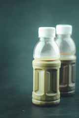 Tasty mocha coffee and cocoa milk in plastic bottle