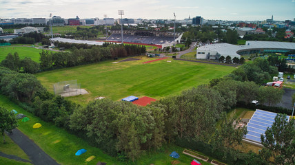 Aerial view of Reykjavik. Sports area with swimming pools, camping sites, footballs, caravans and hostels. Views of the church.