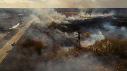 Fototapeta na wymiar Ukraine, Rivne, 04.04.2020, Massive Fire, Dry Grass Lanes in Fire, Firefighters at Work, Disaster, Ecological Catastrophe