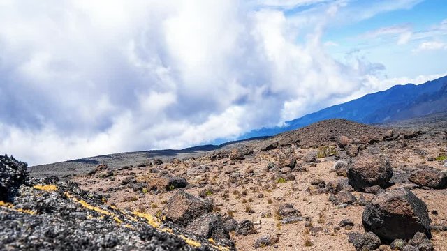 Timelapse view of Kibo with Uhuru Peak (5895m, highest mountain in Africa) at Mount Kilimanjaro, Kilimanjaro National Park. Beautiful landscape with clouds floating over the  volcano.