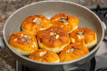 Patties with meat, fried in a granite frying pan in oil. Traditional Kazakh, Tatar and Bashkir food - belyashi.