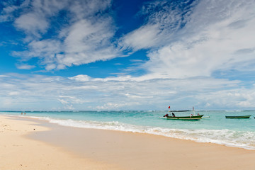 Obraz na płótnie Canvas A fishing boat anchored in a deserted lagoon in Bali, Indonesia.
