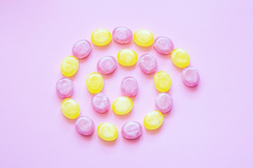 Multicolored candys on a colored background