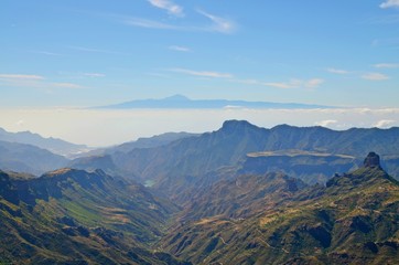 Fototapeta premium Aerial view on Gran Canaria mountainscape towards neigbour island Tenerife with Mount Teide