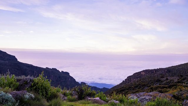 Timelapse view of Kibo with Uhuru Peak (5895m, highest mountain in Africa) at Mount Kilimanjaro, Kilimanjaro National Park. Beautiful landscape with clouds floating over the  volcano.