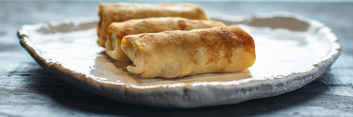 thin pancakes or crepes stuffed chicken meat and vegetables
(hen or turkey) menu concept background. top view. copy space for text