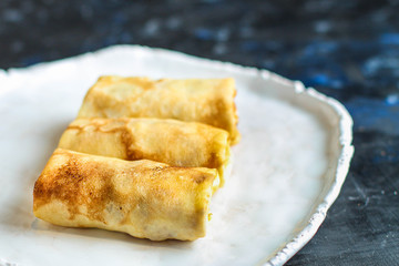 thin pancakes or crepes stuffed chicken meat and vegetables
(hen or turkey) menu concept background. top view. copy space for text