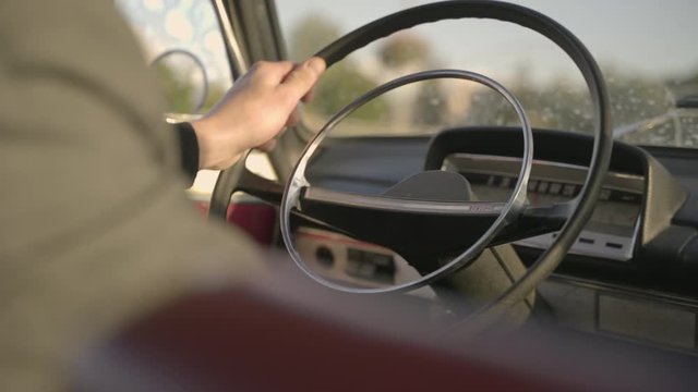 Man drives old soviet car and holds steering wheel