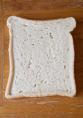 A slice of white bread on a kitchen table