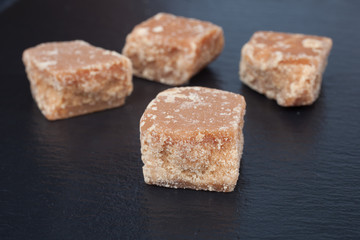 Four pieces of fudge on a black background