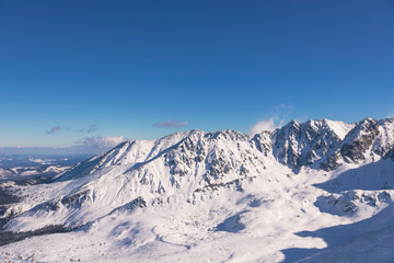Fototapeta na wymiar Ski resort in Poland. High mountain Tatras. Peak Kasprowy near Zakopane. Winter time. Beautiful landscape.