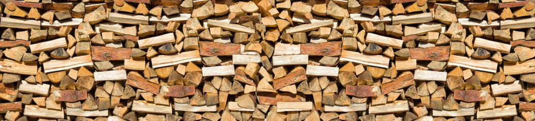 Preparation of firewood for the winter. Firewood background. Background of dry chopped firewood. Wooden background.Stacks of Firewood. 