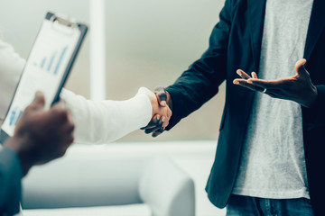 close up. young business people shaking hands with each other