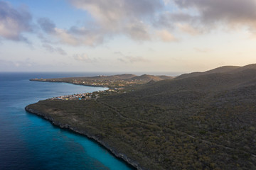 Aerial view of coast of Curacao in the Caribbean Sea with turquoise water, cliff, beach and beautiful coral reef