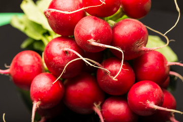 Red radish over black background