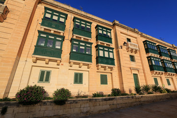 Exterior view of newly renovated residential houses located on top of the fortifications of Valletta, Malta, next to the famous City Gate