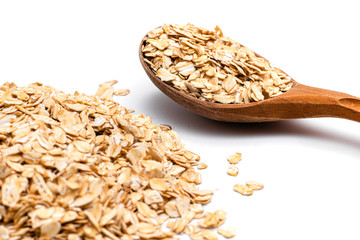 oat flakes and wooden spoon on a white background