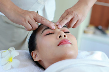 Obraz na płótnie Canvas Woman receive facials, skin treatment by a beautician in a spa salon. woman lying in bed in a beauty clinic Facial care concept