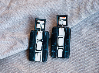 Large black geometric earrings. Handmade jewelry background.