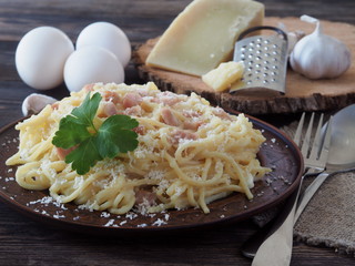 Spaghetti alla Carbonara, traditional italian pasta with egg, guanciale, parmesan and pecorino cheese.
