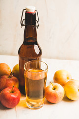 Apple cider in dark bottle made of own farm apples. Selective focus. Shallow depth of field.
