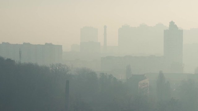 Cityscape in smog. Silhouettes of buildings in the haze. A city with dirty air due to fires. Air pollution