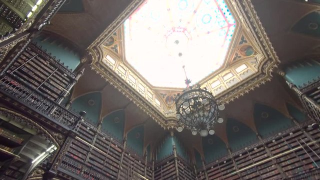 Library Books and bookshelves, in famous Portuguese Reading Room, Rio De Janeiro, Brazil. Rows and rows of books to read and learn in beautiful library. Looking up for knowledge. Rare book collection