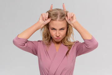 Rebellious charming woman showing inner devil having fun stubborn, smiling broadly playing holding...